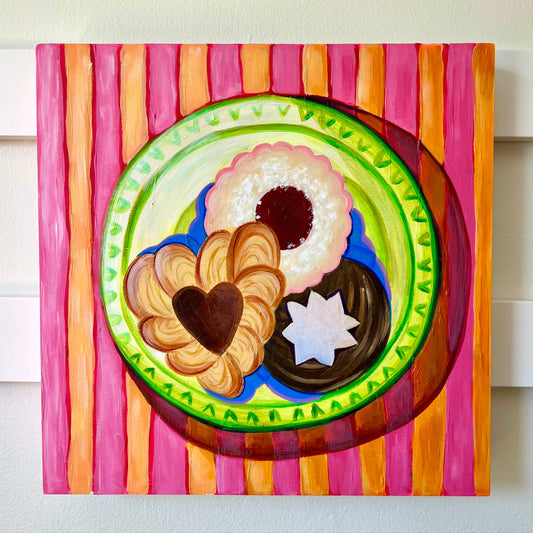 Colorful plate with cookies on a striped background